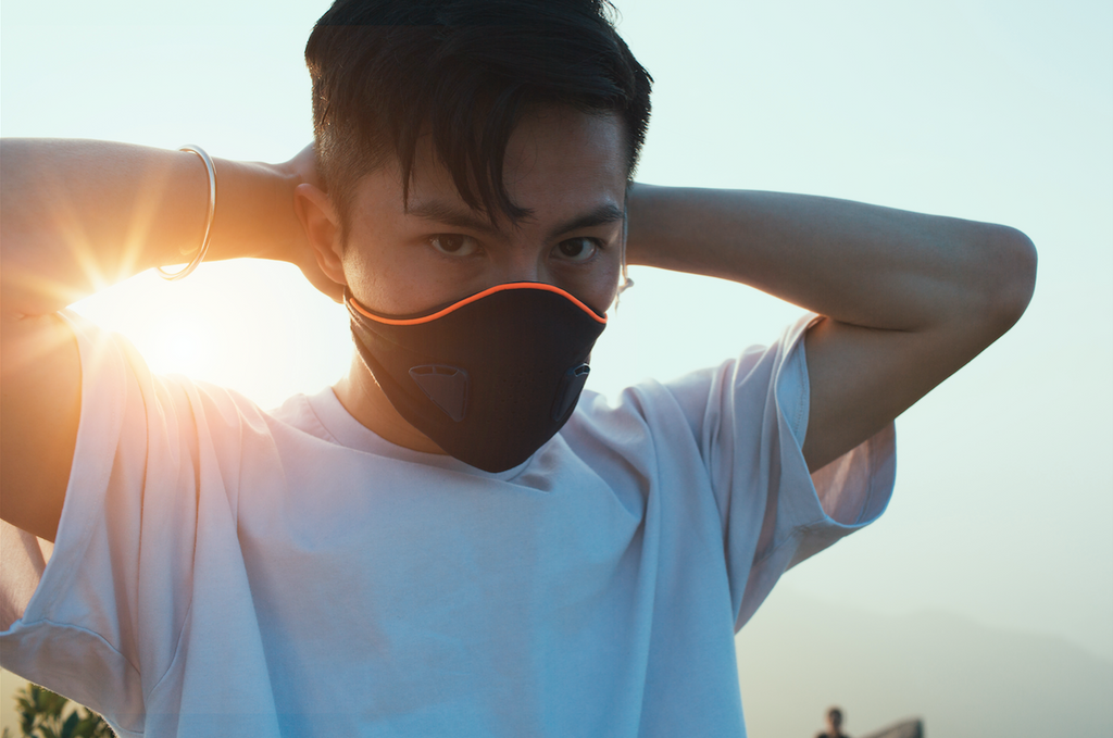 man wearing akmon air pollution facemask in the street